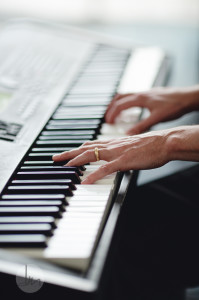 closeup of hands on piano