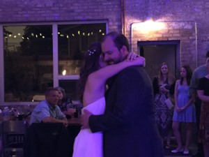 bride and groom dancing at industrial arts