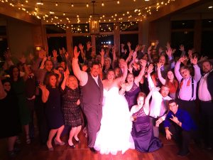 Bride, Groom, and guests celebrating at Geneva National Resort.