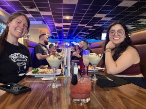 Crowd enjoying dueling pianos and delicious buffet at The Rally Sports Bar & Grille in Warwick