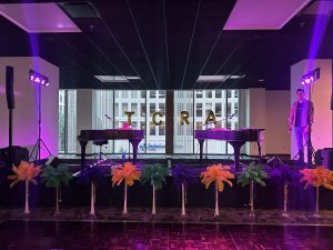 Dueling Pianos performance at Austin Marriott Downtown during a corporate Mardi Gras themed event