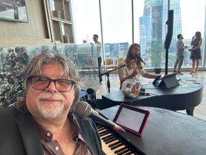 Quintin Dubec performing with Felix And Fingers Dueling Pianos at Residences at 6G in Austin, Texas